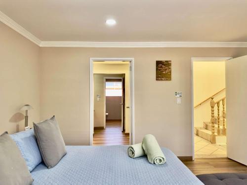 a bedroom with a blue bed and a hallway at Casa Lomas Cozy 3 Bedroom 2 Bath House by Xolos Stadium in Tijuana