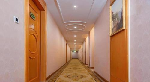a hallway with a long corridor with a corridorngthngthngthngthngthngthngth at Vienna Hotel Guangdong Shantou South Bus Station in Shantou