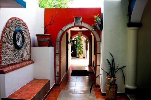 a hallway with an archway in a building at Hotel Zamna Boutique in Mérida