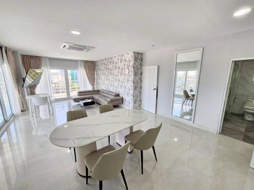 a dining room with a table and a piano at View Talay6 by Blue Ocean Suite in Pattaya Central
