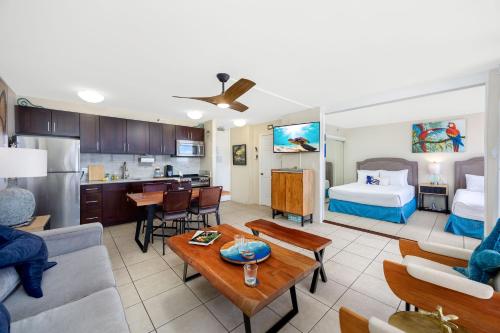 a large living room with a bed and a kitchen at 34FL Deluxe Living in Waikiki - Ocean View Condo with Parking in Honolulu