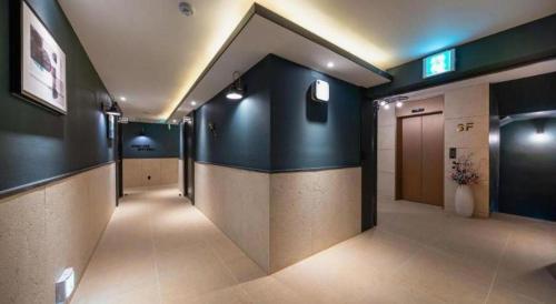 a hallway with a row of stalls in a building at Wonju Bellino Hotel in Wonju