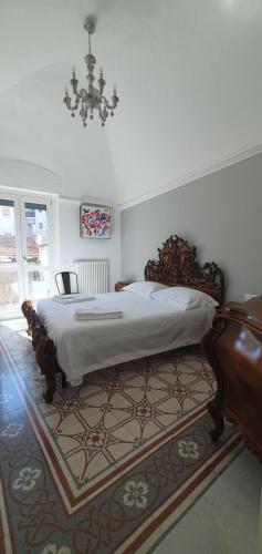 a bedroom with a large bed and a rug at Palazzo Mateola Luxury Rooms in Matera