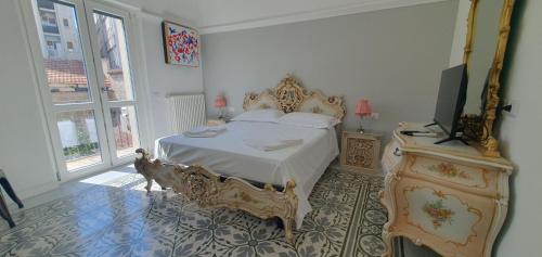a bedroom with a bed and a television in it at Palazzo Mateola Luxury Rooms in Matera