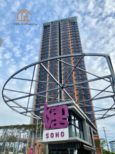 a tall building with a sign in front of it at Cozy Apartment for Two - KANVAS SOHO Cyberjaya in Cyberjaya