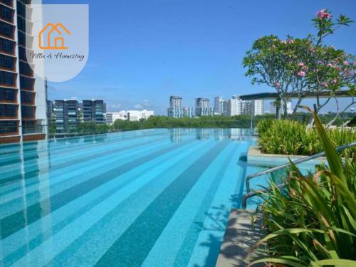 a swimming pool on the roof of a building at Cozy Apartment for Two - KANVAS SOHO Cyberjaya in Cyberjaya