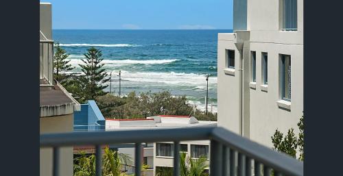 a view of the ocean from a balcony of a building at Kings Beachside Escape spacious apartment centrally located in Caloundra