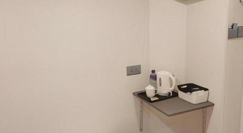 a kitchen with a counter with a toaster on a table at Goodrich Hotel in Hong Kong