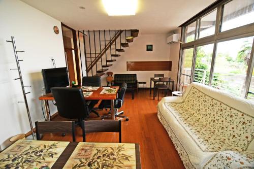 a living room with a couch and a table at 鞆の浦ゲストハウス悠樂 Tomonoura Guest House You Raku in Fukuyama