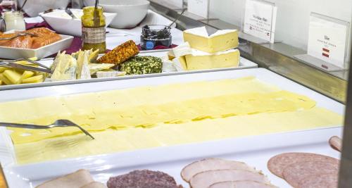 a buffet with cheese and meats and other foods at Best Western Plus Plaza Hotel Graz in Graz