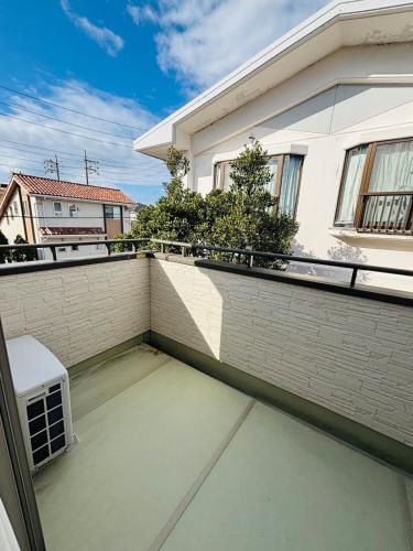 a view of a balcony of a house at ZZOKIAI藍魚 2 mins walk to the beach! Upscale villa area 15 mins from airport! Parking, dryer, baby cots are all available in Itoman