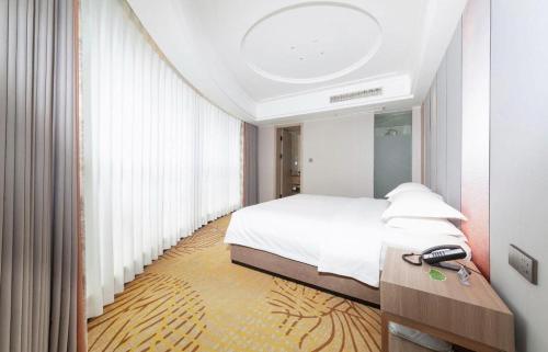 Ένα ή περισσότερα κρεβάτια σε δωμάτιο στο Forstar Hotel Renbei subbranch
