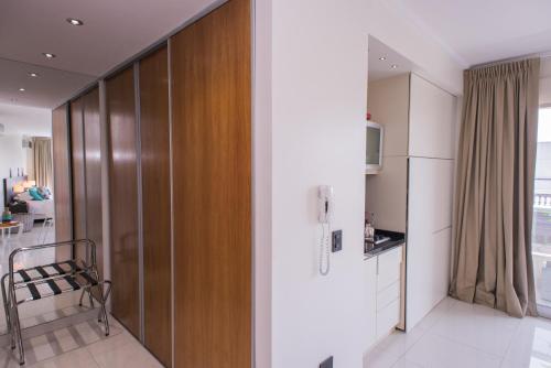 a kitchen and living room with a wooden partition at Soho Luxury Suites in Buenos Aires