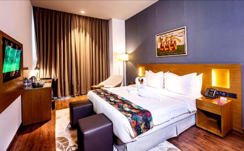a hotel room with a large bed and a television at Hotel Samrat Palace Puri-Bhubaneshwar-Odisha Near Sea-View With Free Wi-Fi and Parking in Puri