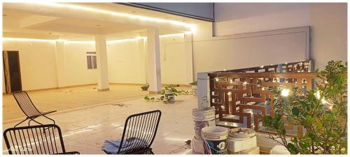 an empty room with two chairs and a staircase at Hotel !! Anand - Palace Near Banaras Railway Station - Offers Budget Rooms With Wi-fi Facility - A Comfort Stay Guest House In Varanasi in Varanasi