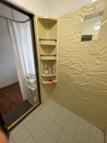 a refrigerator with its door open in a room at Minpaku ayu B in Nago