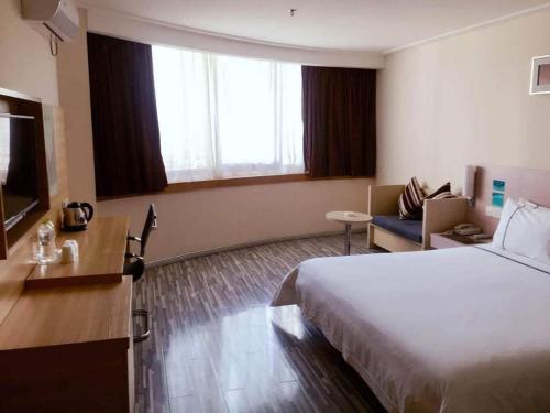 a hotel room with a bed and a couch at City Comfort Inn Nanning Guangxi University in Nanning