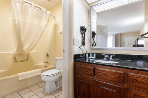 a bathroom with a sink and a toilet and a mirror at Quality Inn Cheraw in Cheraw