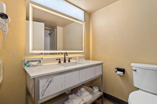 a bathroom with a sink and a mirror at Quality Inn & Suites North Myrtle Beach in Myrtle Beach