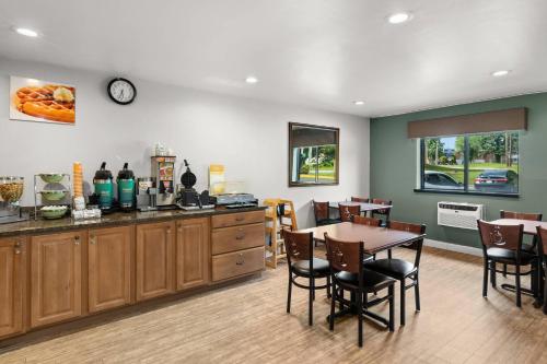 a kitchen and dining room with a table and chairs at Quality Inn Atlanta Airport-Central in Atlanta