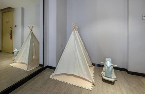 two model tents on display in a room at Echarm Hotel Beihai Railway Station in Beihai