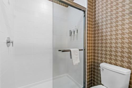a bathroom with a toilet and a glass shower at Home2 Suites By Hilton Marion in Marion