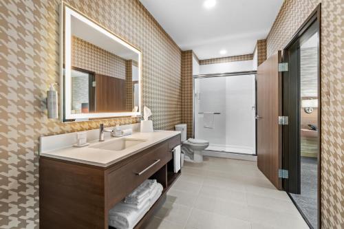 a bathroom with a sink and a toilet and a mirror at Home2 Suites By Hilton Marion in Marion