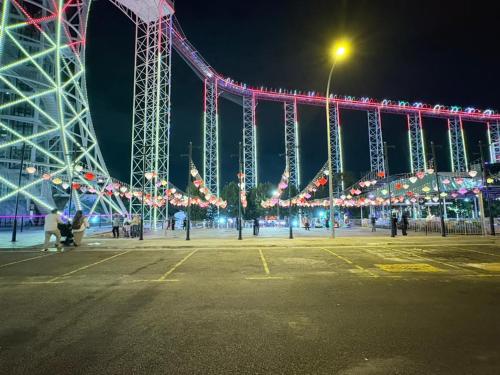 a large ferris wheel with christmas lights at night at Wyndham Garden i-City Shah Alam in Shah Alam