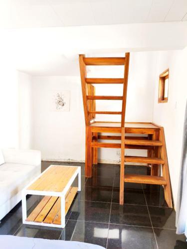 a wooden ladder in a living room with a couch at Kondo Villa in Labuhan Pandan
