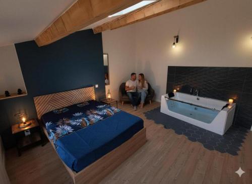 a man and woman sitting in a room with a tub at Escapade bien-être avec Sauna et Balnéo - ChezBross' La Parenthèse in Aboën
