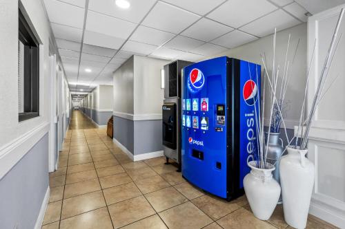 a hallway with a soda vending machine in a building at Days Inn & Suites by Wyndham Lakeland in Lakeland