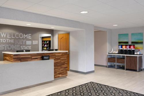 a lobby with a welcome to the new store starter at Hampton Inn & Suites Wilkes-Barre in Wilkes-Barre