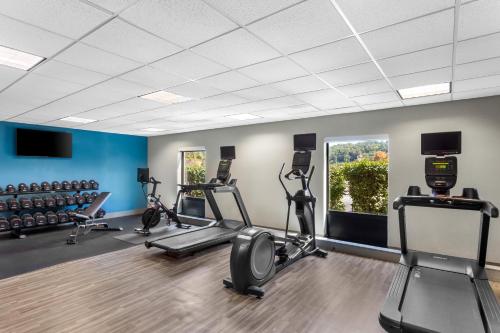 a gym with several treadmills and elliptical machines at Hampton Inn University Area, Huntington, Wv in Huntington