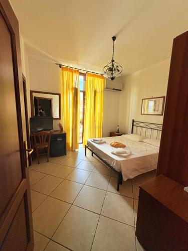 a bedroom with a bed and a table and a window at Hotel Savoia in Sapri