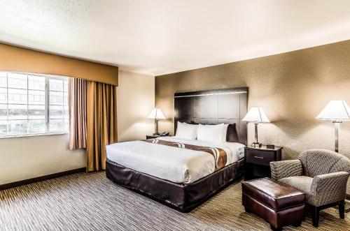 a hotel room with a bed and a chair at Quality Inn & Suites Westminster - Broomfield in Westminster