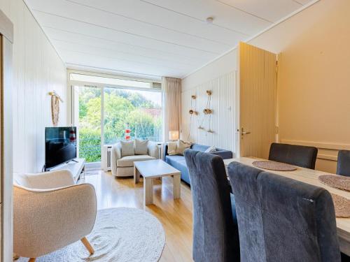 a living room with a couch and a table at Attractive apartment near Vlissingen beach in Vlissingen
