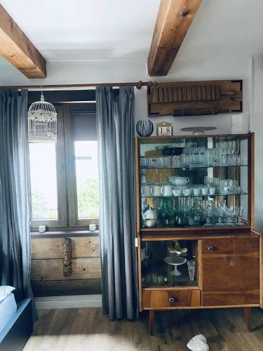 a room with a cabinet with dishes in it at Magnusowe Siedlisko in Budy Chojnackie