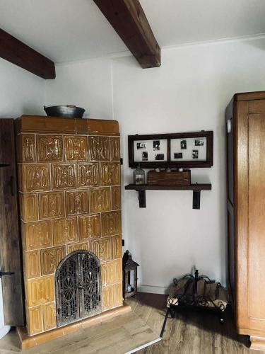 a living room with a stone fireplace in a room at Magnusowe Siedlisko in Budy Chojnackie