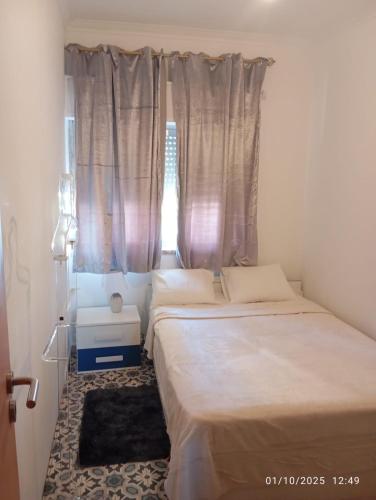 two beds in a room with a window at Helder&Joana Five Star Holiday in Póvoa de Santa Iria
