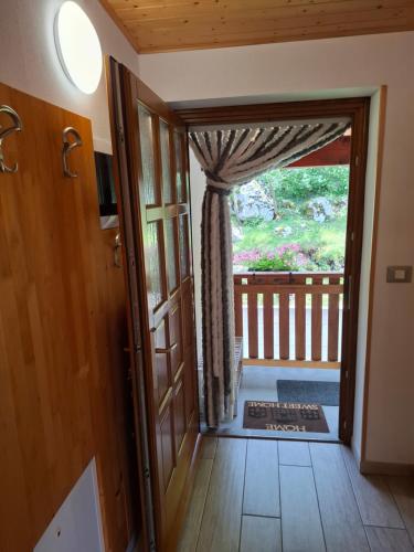 an open door leading to a balcony with a view at APARTMA ANA IDA in Srpenica