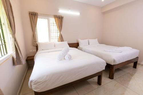 a bedroom with two beds with towels on them at Blue Mount in Kuilapayam