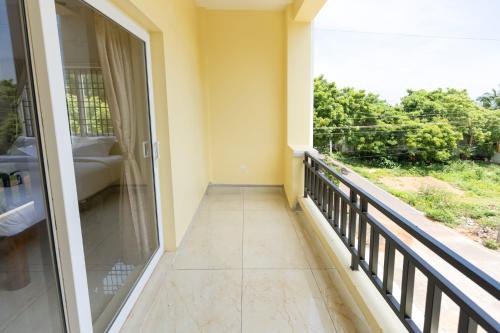 a balcony with a large glass door and a view at Blue Mount in Kuilapayam