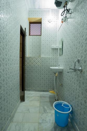 a bathroom with a sink and a bucket at Peace & Joy in Jaisalmer