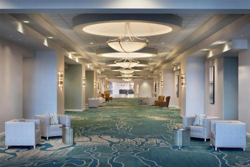 a lobby of a hotel with chairs and a hallway at Embassy Suites San Marcos Hotel Conference Center in San Marcos