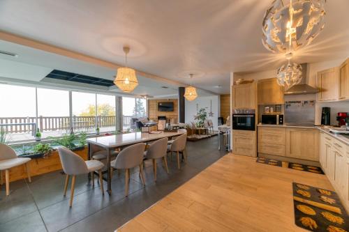 a kitchen with a table and chairs and a dining room at Vacances de rêves - Olympique in Chamrousse