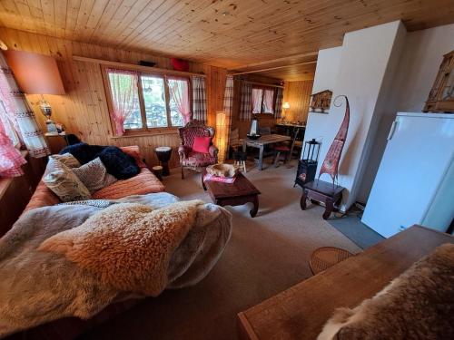 a living room with a couch and a table at Chalet Chnorz Exclusive Private in Nesslau