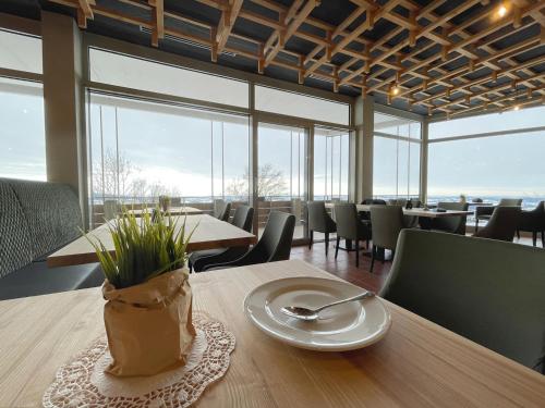 a dining room with tables and chairs and windows at Inviting apartment in Freyung with sauna & indoor pool in Freyung
