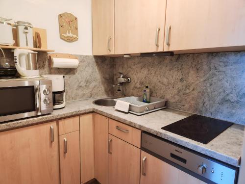 a kitchen with a sink and a microwave at Inviting apartment in Freyung with sauna & indoor pool in Freyung