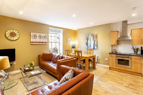 a living room with a couch and a table at The Old Toffee Works, Montpellier Quarter, Next to Pump Rooms FREE PARKING in Harrogate