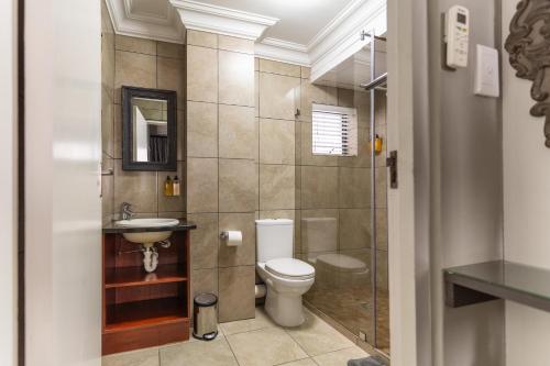 a bathroom with a toilet and a sink and a shower at Avemore Eikehoff No 26 full power back up in Stellenbosch